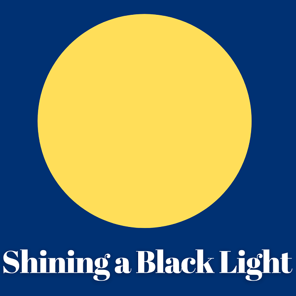 Blue box with a yellow circle and the text Shining a Black Light